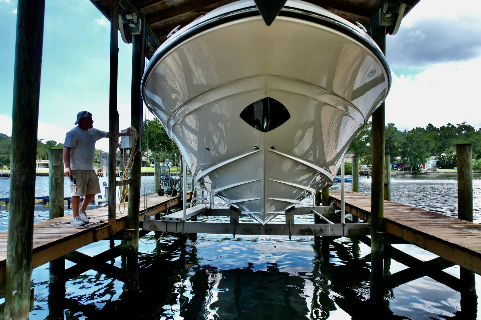 Technician detailing the bow section of a boat during a complete detail